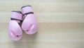 Breast cancer awareness concept with pink boxing gloves for girl and woman sports fight and recreational exercise on white wood Royalty Free Stock Photo