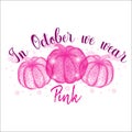 Breast cancer awareness month concept with three pumpkins and text In October we wear pink