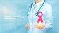 Breast Cancer Awareness Month. Doctor holding in hand the pink ribbon breast cancer awareness symbol. Healthcare, International Royalty Free Stock Photo