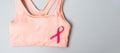 Breast Cancer Awareness month, Pink Ribbon on female sport bar on grey background for supporting people living and illness. Royalty Free Stock Photo