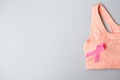 Breast Cancer Awareness month, Pink Ribbon on female sport bar on grey background for supporting people living and illness. Royalty Free Stock Photo