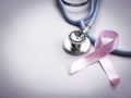 Breast cancer awareness pink ribbon with doctor stethoscope on pink background, october symbol, healthcare and medicine concept Royalty Free Stock Photo