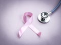 Breast cancer awareness pink ribbon with doctor stethoscope on pink background, october symbol, healthcare and medicine concept Royalty Free Stock Photo