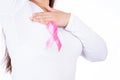 Breast cancer awareness ribbon on woman chest and doing self exam isolated over white background. Medical, healthcare for Royalty Free Stock Photo