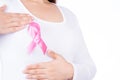 Breast cancer awareness ribbon on woman chest and doing self exam isolated over white background. Medical, healthcare for Royalty Free Stock Photo