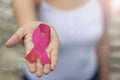 Breast cancer awareness. Woman hand holding pink ribbon Royalty Free Stock Photo