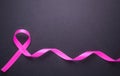 Breast Cancer concept : Pink ribbon symbol of breast cancer on b