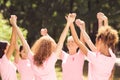 Female Volunteers Supporting Oncology Awareness Campaign Holding Hands Standing Outdoors Royalty Free Stock Photo