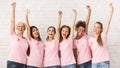 Breast Cancer Volunteers Raising Hands Supporting Awareness Campaign Indoor Royalty Free Stock Photo