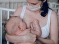 Breastfeeding baby eating milk from mother`s breast and bottle. Concept - breastfeeding and motherhood Royalty Free Stock Photo