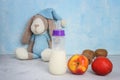 Breastfeeding and healthy food. Breastfeeding mom`s diet. Milk, children`s toy, fruits on blue background. Copyspace