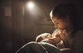 Breastfeeding. mother feeding baby breast in bed dark night Royalty Free Stock Photo