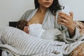 Breastfeeding mother using a smartphone