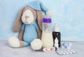 Breastfeeding and pills .Medication and lactation. Milk, children`s toy, thermometer, syrop, pills and pacifier on blue backgroun