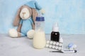 Breastfeeding and pills .Medication and lactation. Milk, children`s toy, thermometer, syrop, pills and pacifier on blue backgroun