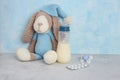 Breastfeeding and pills. Stopping breastfeeding with medication. Milk, children`s toy. pills and pacifier on blue background.