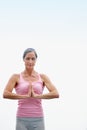 Breathe. Believe. Receive.an attractive mature woman doing yoga outdoors.