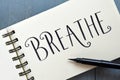 BREATHE hand-lettered in notepad with brush pen Royalty Free Stock Photo