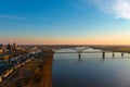 A breathtaking aerial shot of the running waters of the Mississippi river with powerful clouds and a stunning sunset