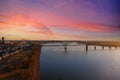 A breathtaking aerial shot of the running waters of the Mississippi river with powerful clouds and a stunning sunset