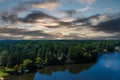 A breathtaking aerial shot of the still blue waters of the lake with vast miles of lush green trees with homes and boat docks Royalty Free Stock Photo