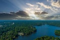 A breathtaking aerial shot of the still blue waters of the lake with vast miles of lush green trees with homes and boat docks Royalty Free Stock Photo