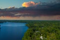 A breathtaking aerial shot of the still blue waters of the lake with vast miles of lush green trees with homes and boat docks Royalty Free Stock Photo