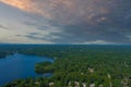 A breathtaking aerial shot of the still blue waters of the lake with vast miles of lush green trees with homes and boat docks Royalty Free Stock Photo