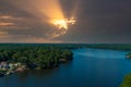 A breathtaking aerial shot of the still blue waters of the lake with vast miles of lush green trees with homes and boat docks Royalty Free Stock Photo