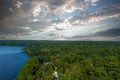 A breathtaking aerial shot of the still blue waters of the lake with vast miles of lush green trees with homes and boat docks Royalty Free Stock Photo