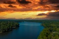 A breathtaking aerial shot of the still blue waters of the lake with vast miles of lush green trees with homes and boat docks Royalty Free Stock Photo