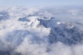 Beautiful aerial view of snow capped mountain peaks above clouds Royalty Free Stock Photo