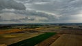 Breathtaking aerial view of a sprawling countryside with lush green fields and small buildings