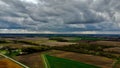 Breathtaking aerial view of a sprawling countryside with lush green fields and small buildings