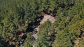 Breathtaking aerial view - a very dense forest of pine trees, a road in the clouds and an observation deck on the island Royalty Free Stock Photo