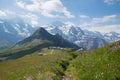 Breathtaking alpine landscape switzerland. meadow with bluebells. view to Tschuggen and Jungfrau mountain Royalty Free Stock Photo