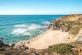 Breathtaking cliffs surround the sandy beach of Praia da Angra da Cerva on the Atlantic coast near Vila Nova de Milfontes, Odemira Royalty Free Stock Photo