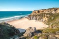 Breathtaking cliffs surround the sandy beach of Praia da Angra da Cerva on the Atlantic coast near Vila Nova de Milfontes, Odemira Royalty Free Stock Photo