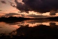 Breathtaking dark sunset cloudscape and its reflection in the river Royalty Free Stock Photo