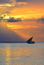 Breathtaking golden sunset with a silhouetted boat sailing along its journey against a vivid colorful sky Royalty Free Stock Photo