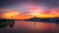 Breathtaking high angle view of a river next to the city and the colorful sunset sky