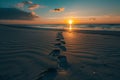 Serene Beach Sunset with Footprints, Tranquil Nature Scene Royalty Free Stock Photo