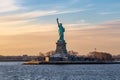 Breathtaking image of the iconic Statue of Liberty in New York City, USA under a stunning sunset sky Royalty Free Stock Photo