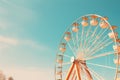 A breathtaking image of a massive ferris wheel towering over a wide, open field in the countryside, Vintage ferris wheel on a blue Royalty Free Stock Photo