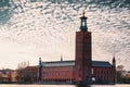 Breathtaking image showcases a majestic red building situated on a tranquil body of blue water