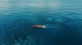 An awe-inspiring aerial shot of a lone fishing boat navigating the vast expanse of the ocean. Royalty Free Stock Photo