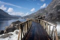 Breathtaking landscape of the Hetch Hetchy Reservoir featuring a picturesque wooden bridge