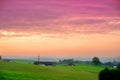 Breathtaking lansdcape of Austrian countryside on sunset. Dramatic sky over idyllic green fields of Anstrian Central Alps on autum Royalty Free Stock Photo