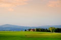 Breathtaking lansdcape of Austrian countryside on sunset. Dramatic sky over idyllic green fields of Anstrian Central Alps on autum