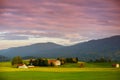 Breathtaking lansdcape of Austrian countryside on sunset. Dramatic sky over idyllic green fields of Anstrian Central Alps on autum Royalty Free Stock Photo